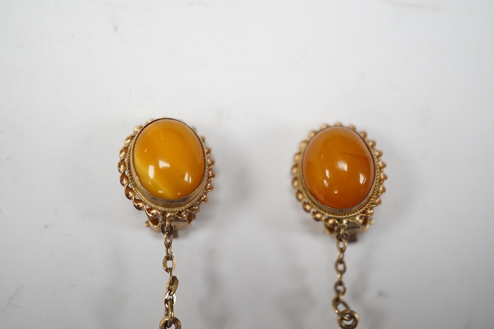 A pair of yellow metal and two stone amber set drop ear clips, 68mm, gross weight 8 grams. Condition - poor